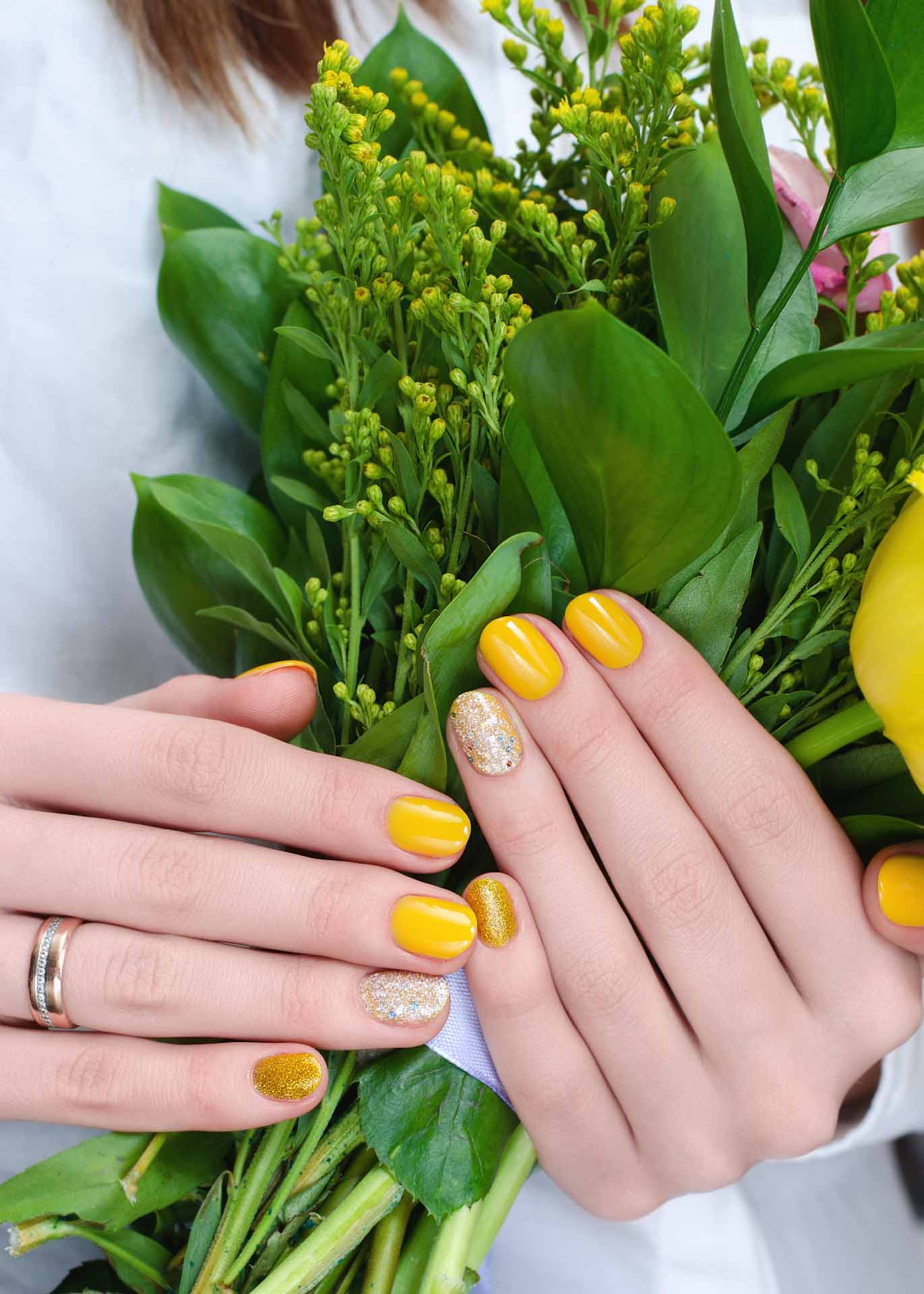 Yellow flowers in woman hands.