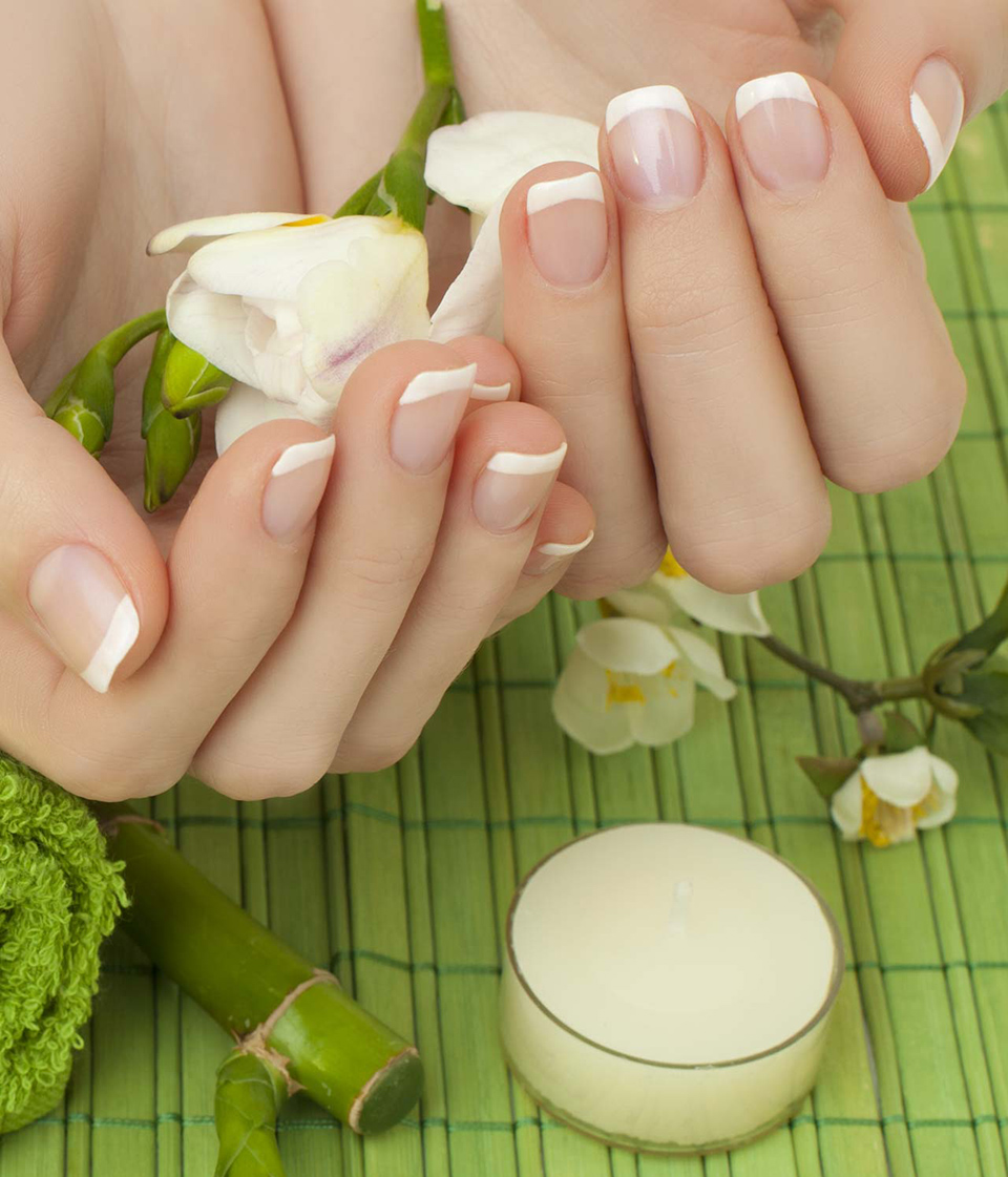 Manicure - hands with natural nails, beauty salon background
